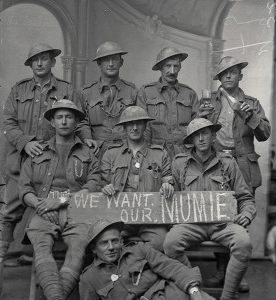 A group of 2nd Division soldiers holding a sign saying WE WANT OUR MUMIE