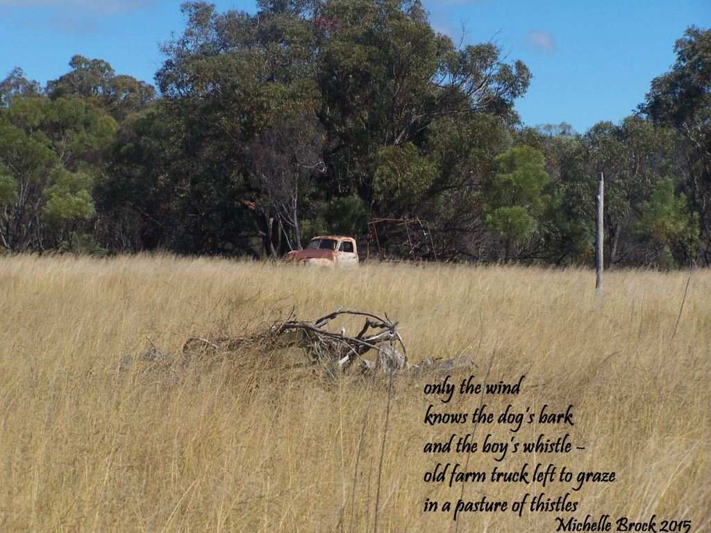 Haiga over picture of farm paddock: only the wind / knows the dog's bark / and the boy's whistle – / old farm truck left to graze / in a pasture of thistles
